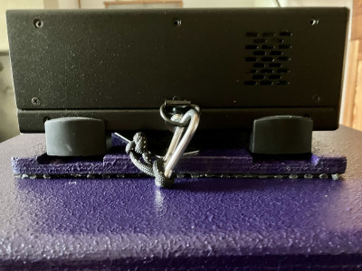 Amp head with tether clipped onto D-ring (side view)