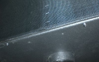 Countersunk, non threaded hole in cabinet.  Threaded hole in frame of the grill.