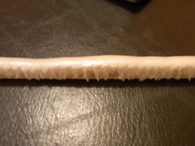 This is what it looks like once it's been scraped off. Note the honeycomb bubble effect that it gets on the inside.