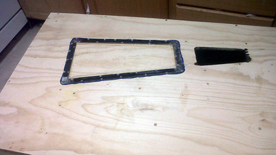 Sealing the the driver chamber with Blue RTV silicone gasket maker, we use small strips of wax paper between the driver panel surface the driver panel access cover to make future access easier.