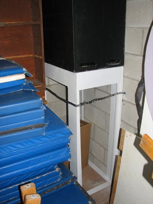 The riser strapped to the wall.