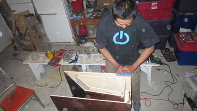 All the edges finally met up but the still was a slight discrepancy in the panels widths. So were sanding the highs down so the side panels fits tight.